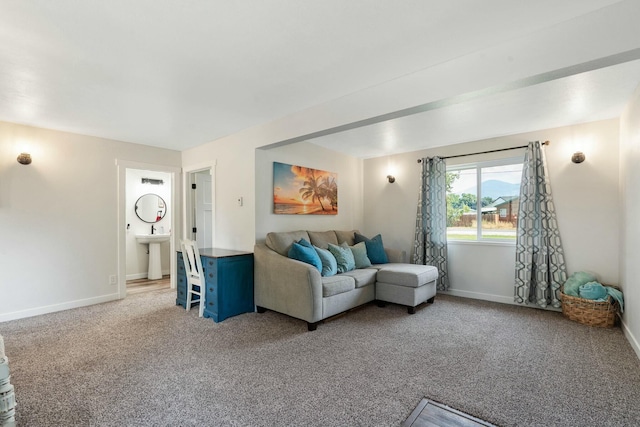 living room with baseboards and light colored carpet