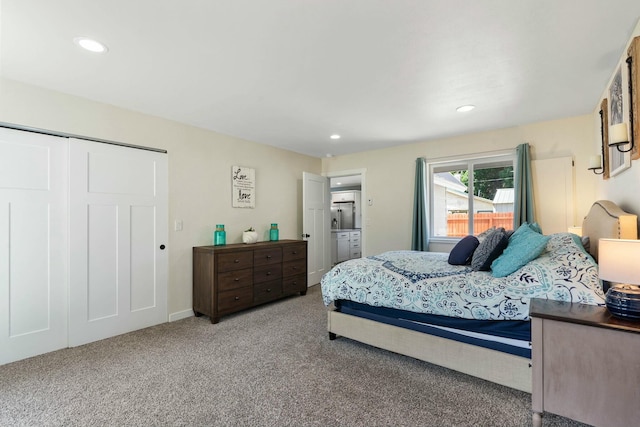 bedroom with a closet, carpet flooring, and recessed lighting