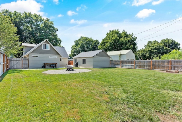 view of yard with a fire pit, a gate, a patio area, and a fenced backyard