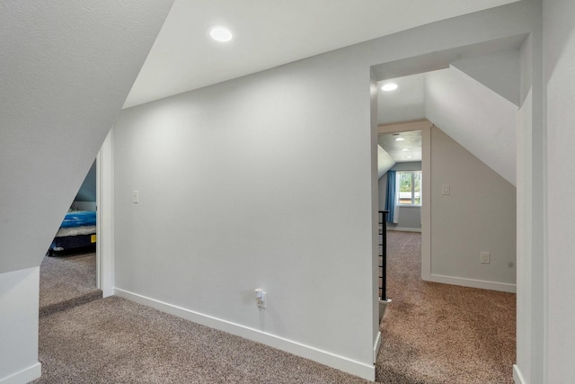 additional living space featuring baseboards, vaulted ceiling, carpet flooring, and recessed lighting