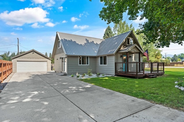 view of front of home featuring a garage, a front lawn, an outdoor structure, metal roof, and a wooden deck
