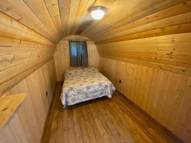158 Teal Rd, Usk, WA 99180 - bedroom with wood walls, vaulted ceiling, wood-type flooring, and wooden ceiling