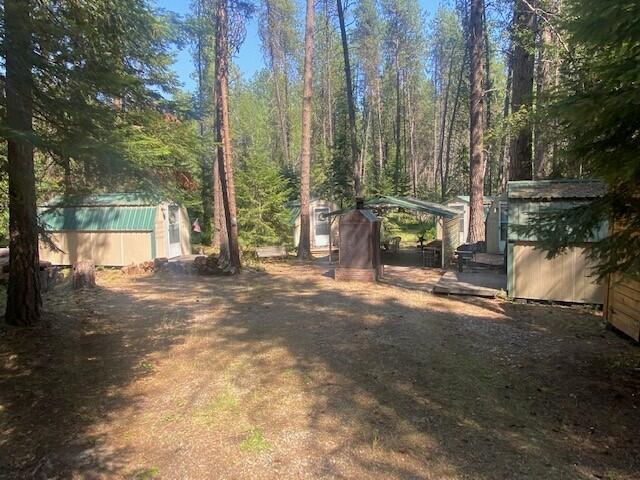 158 Teal Rd, Usk, WA 99180 - view of yard featuring a storage unit and an outdoor structure