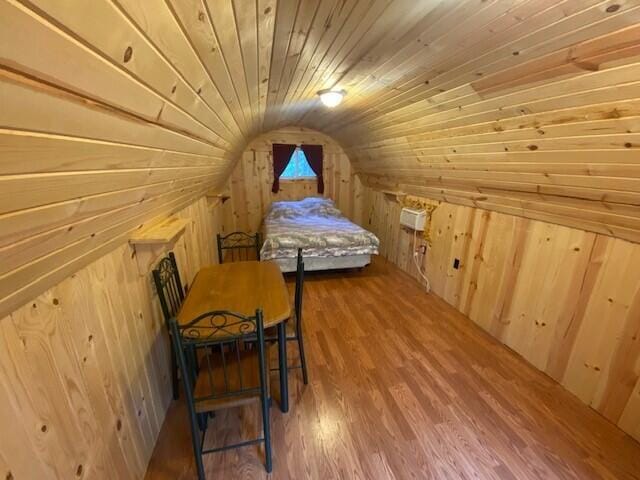 158 Teal Rd, Usk, WA 99180 - bedroom with vaulted ceiling, wooden walls, wood ceiling, and wood finished floors