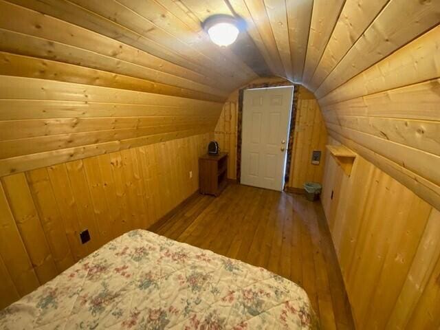158 Teal Rd, Usk, WA 99180 - bedroom featuring wood walls, hardwood / wood-style flooring, lofted ceiling, and wooden ceiling