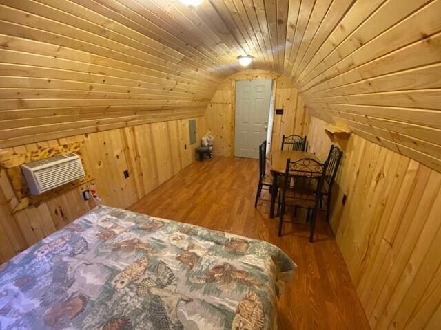 158 Teal Rd, Usk, WA 99180 - bedroom with vaulted ceiling, wood walls, wood finished floors, wooden ceiling, and a wall mounted AC