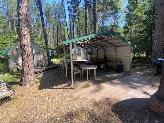158 Teal Rd, Usk, WA 99180 - view of patio with a storage unit and an outdoor structure