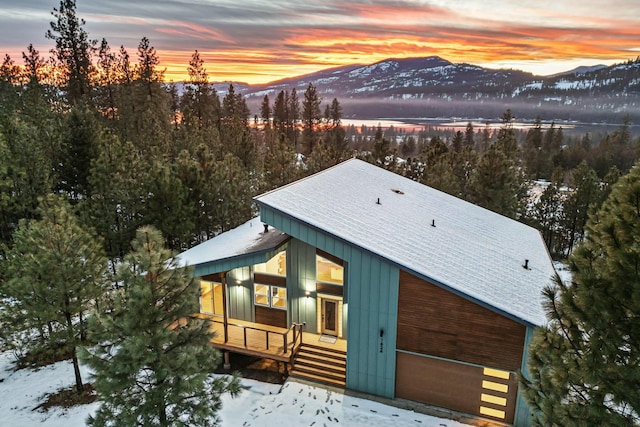 snowy aerial view featuring a mountain view