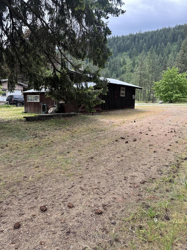 view of yard featuring a wooded view