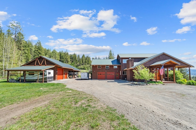 40 Happy Jack Rd, Curlew, WA 99118 - chalet / cabin with dirt driveway, metal roof, a front lawn, and a garage