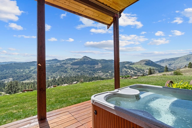 40 Happy Jack Rd, Curlew, WA 99118 - wooden deck featuring a hot tub, a mountain view, and a lawn