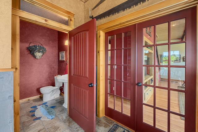 40 Happy Jack Rd, Curlew, WA 99118 - bathroom featuring toilet, french doors, baseboards, and a textured wall