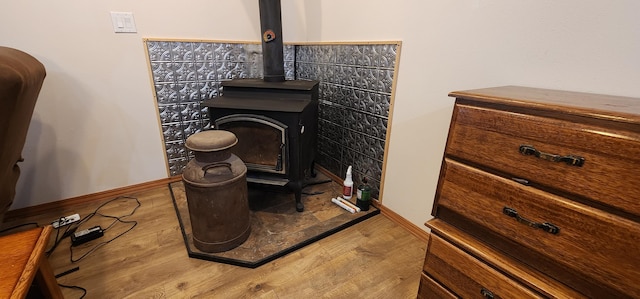 1527 Pingston Creek Rd, Kettle Falls, WA 99141 - room details featuring baseboards, a wood stove, and wood finished floors