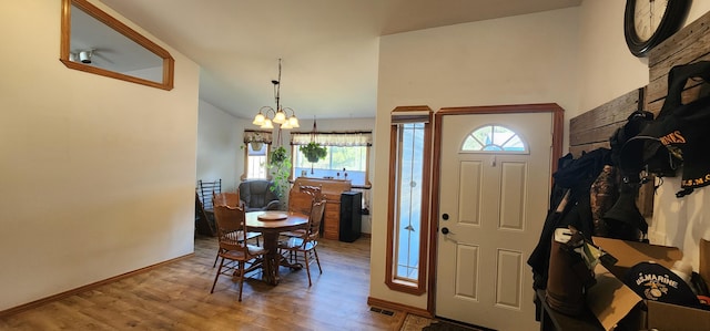 1527 Pingston Creek Rd, Kettle Falls, WA 99141 - entrance foyer featuring a wealth of natural light, wood finished floors, visible vents, and a notable chandelier