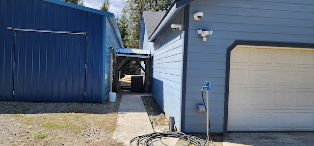 1527 Pingston Creek Rd, Kettle Falls, WA 99141 - view of side of home featuring a garage, an outbuilding, and central AC
