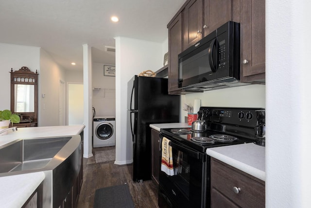 kitchen featuring dark hardwood / wood-style floors, washer / clothes dryer, sink, black appliances, and dark brown cabinets