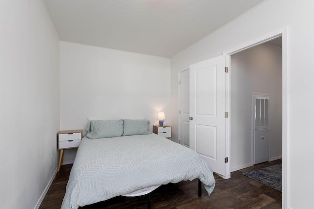 bedroom with dark hardwood / wood-style floors