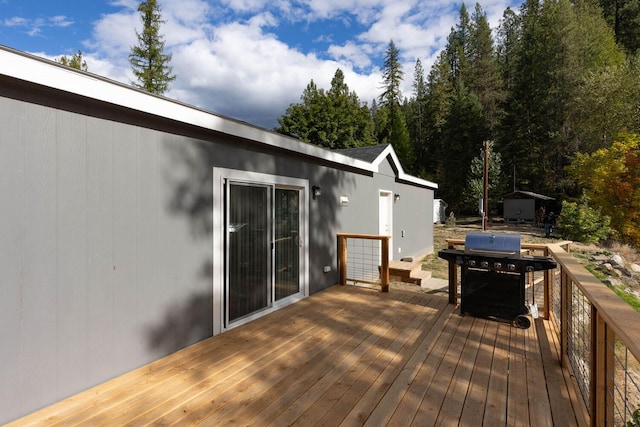 wooden terrace featuring grilling area