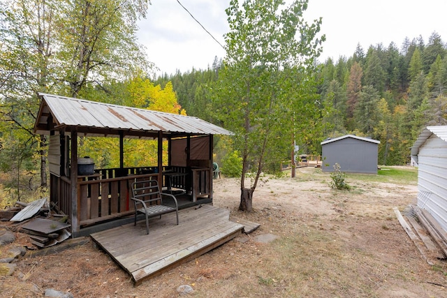 wooden terrace featuring a storage shed