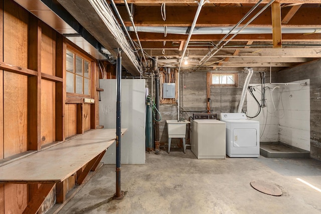 basement with sink, electric panel, and washing machine and dryer