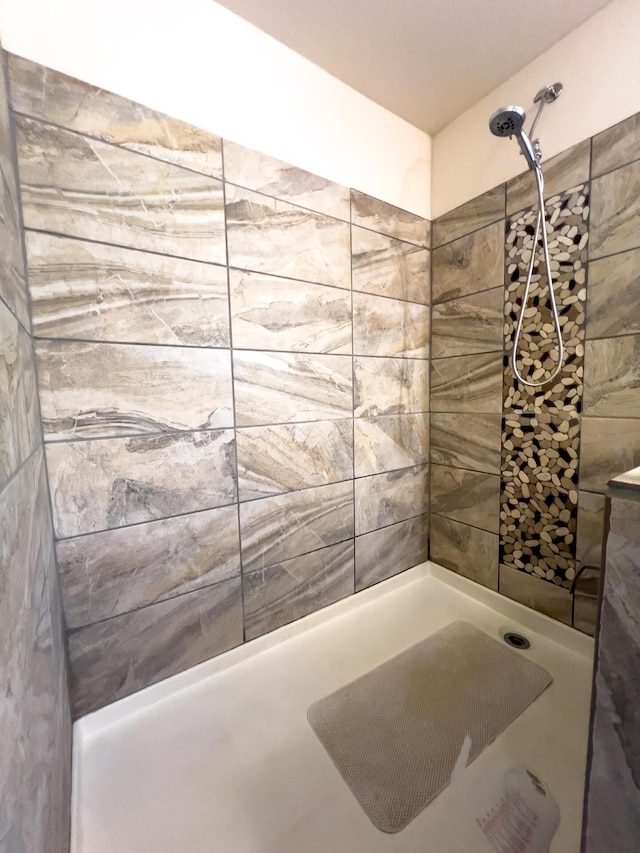 bathroom with tiled shower