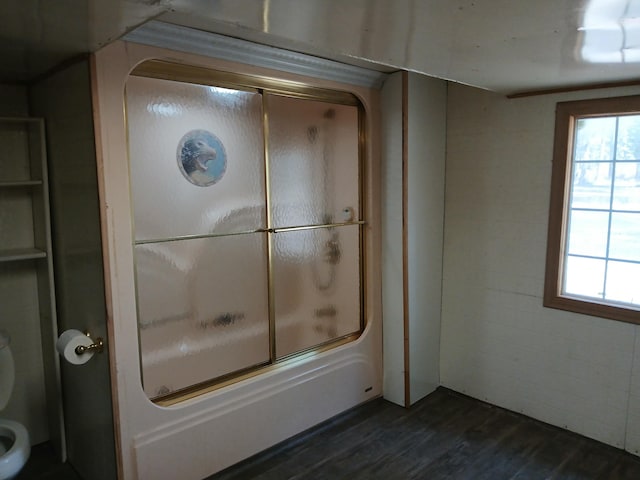 4224 Grouse Creek Rd Unit C, Loon Lake, WA 99148 - bathroom with toilet, a healthy amount of sunlight, wood finished floors, and combined bath / shower with glass door