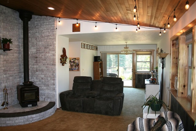 4738 Price Rd, Clayton, WA 99110 - living area featuring carpet flooring, a wood stove, vaulted ceiling, wooden ceiling, and rail lighting