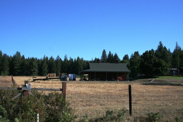 4738 Price Rd, Clayton, WA 99110 - view of yard with fence, a wooded view, and a view of countryside