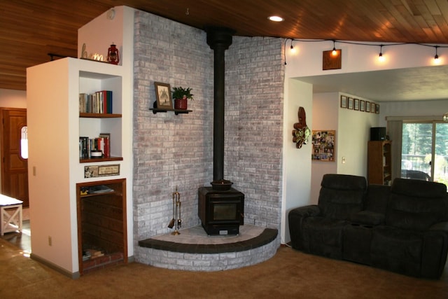 4738 Price Rd, Clayton, WA 99110 - living area featuring wood ceiling, a wood stove, carpet, and brick wall