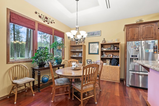 420 Palmer Ln, Chewelah, WA 99109 - dining area with an inviting chandelier, a raised ceiling, and dark wood-style flooring