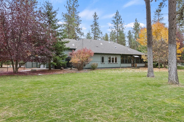 420 Palmer Ln, Chewelah, WA 99109 - rear view of property featuring a lawn, a shingled roof, and a sunroom