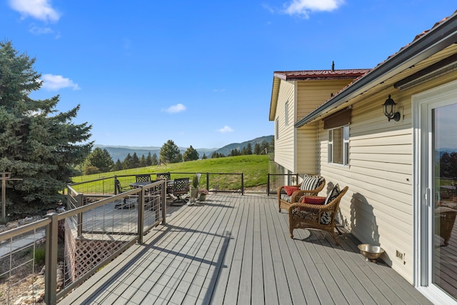 wooden deck with a mountain view and a rural view