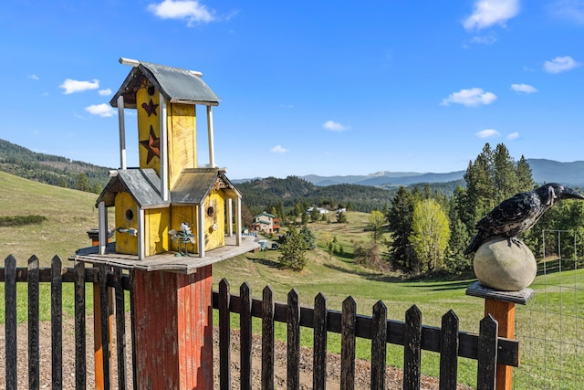 view of yard featuring fence and a mountain view