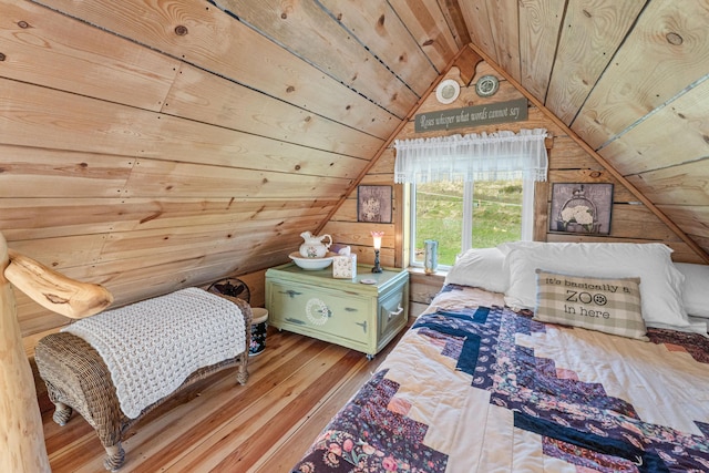 bedroom with wooden walls, wooden ceiling, hardwood / wood-style floors, and lofted ceiling