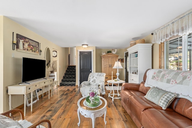 living area with wood-type flooring and stairway