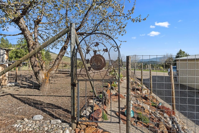 view of yard with a mountain view and fence