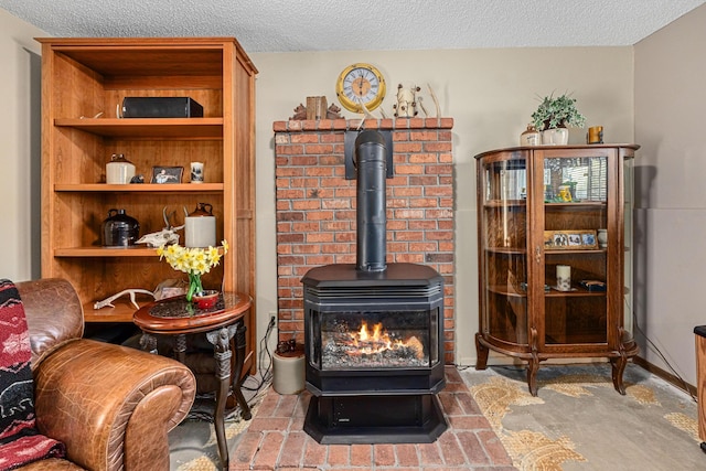 sitting room with a wood stove and a textured ceiling