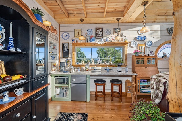 717 Conrad Hill Way, Colville, WA 99114 - bar with wood ceiling with exposed beams, freestanding refrigerator, light wood-style floors, built in microwave, and healthy amount of natural light