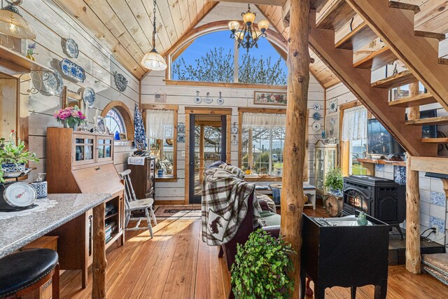 foyer entrance with a healthy amount of sunlight, wooden walls, hardwood / wood-style floors, and wooden ceiling