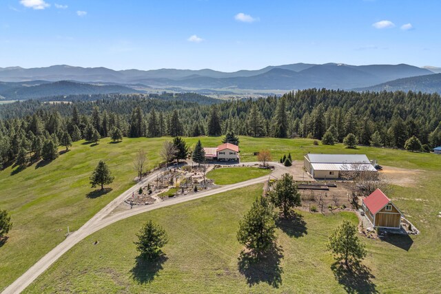 drone / aerial view with a mountain view and a wooded view