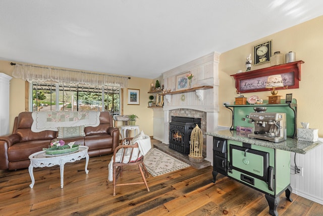 living area featuring a tiled fireplace and wood finished floors
