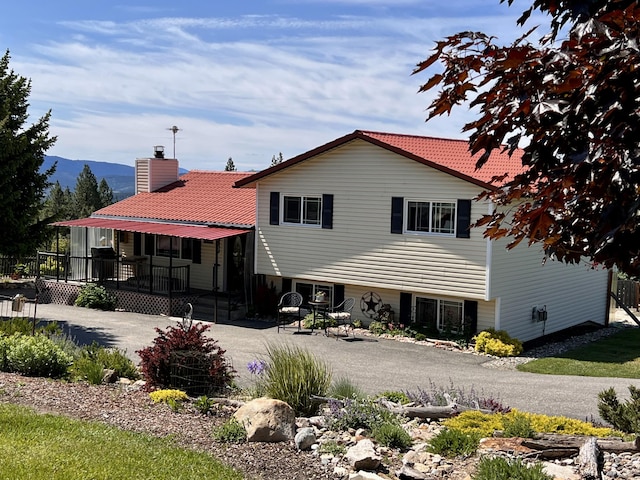 717 Conrad Hill Way, Colville, WA 99114 - back of property featuring a deck with mountain view and a chimney