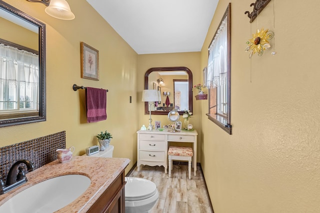 bathroom with vanity, plenty of natural light, and toilet