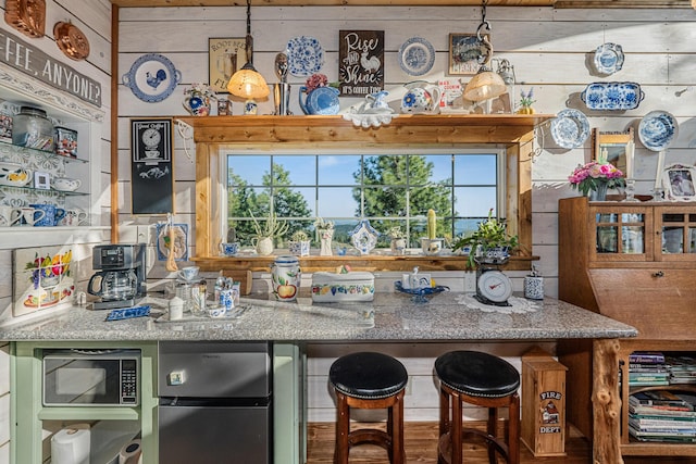 bar with freestanding refrigerator and built in microwave