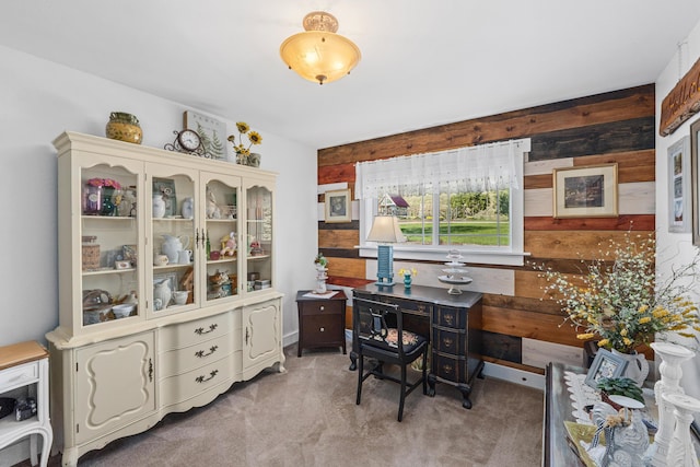home office featuring wooden walls and light colored carpet