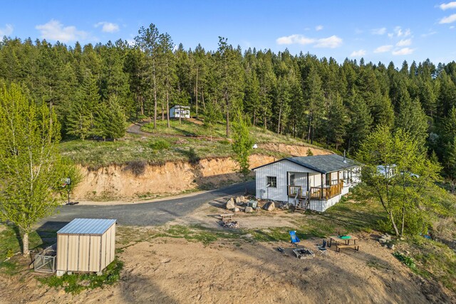 aerial view featuring a wooded view