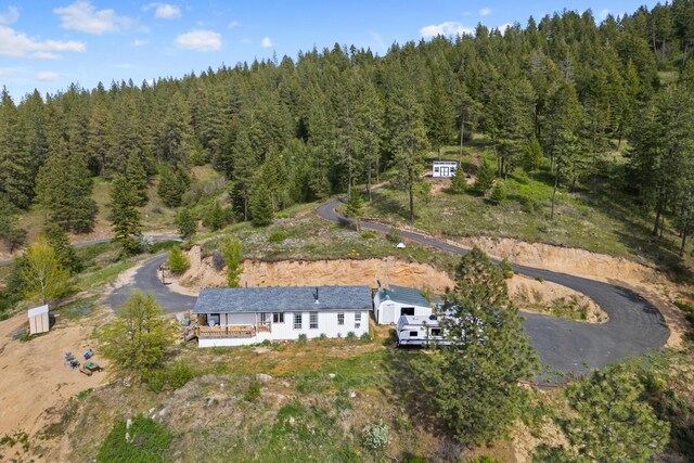 birds eye view of property with a wooded view