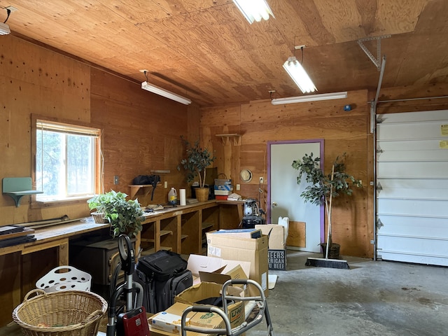 11 Crestview Dr, Kettle Falls, WA 99141 - miscellaneous room featuring wood walls, wooden ceiling, concrete flooring, and a workshop area