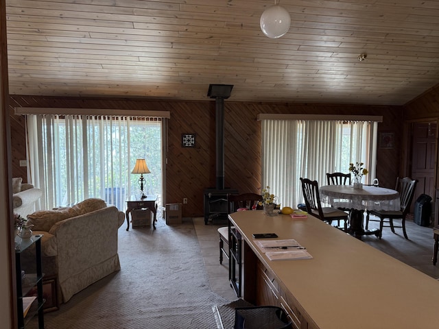 11 Crestview Dr, Kettle Falls, WA 99141 - dining space with a wood stove, wooden walls, and vaulted ceiling
