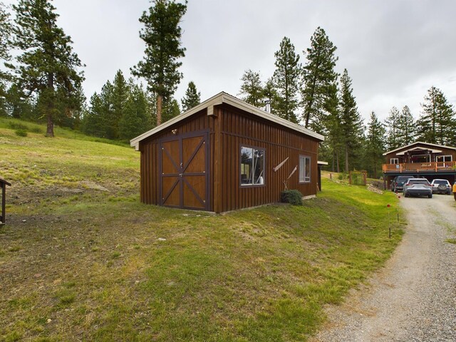 view of outbuilding featuring a yard